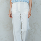 Fresh Light Blue Sleeveless Top With Ruffled Details Paired With White Wide-leg Pants.