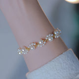 PULSERA CLÁSICO PERLA PERLÉ PATTE DE CHAT PLAQUÉ ORO RÉGLABLE