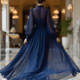 VESTIDO LARGO AZUL MARINO SEMITRANSPARENTE CON CUELLO ALTO Y CINTURÓN - VALERINA MARBELLA