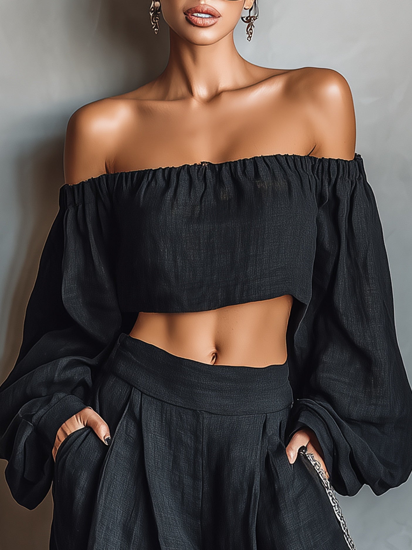 Conjunto de blusa preta de manga comprida com ombros à mostra e calça pantalona