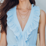 Fresh Light Blue Sleeveless Top With Ruffled Details Paired With White Wide-leg Pants.